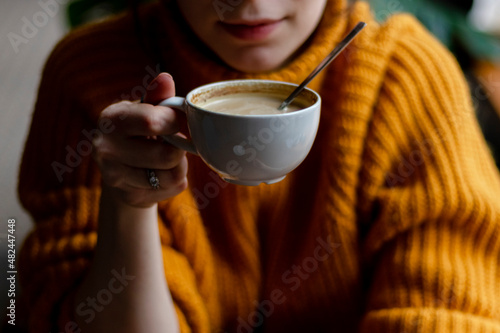 Woman in a cafe drinking coffee