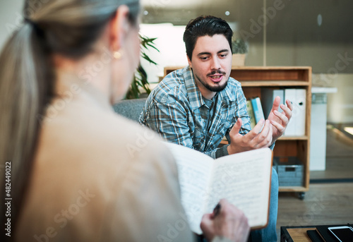Sometimes I feel like.... Shot of a young man having a therapeutic session with a psychologist and looking upset.