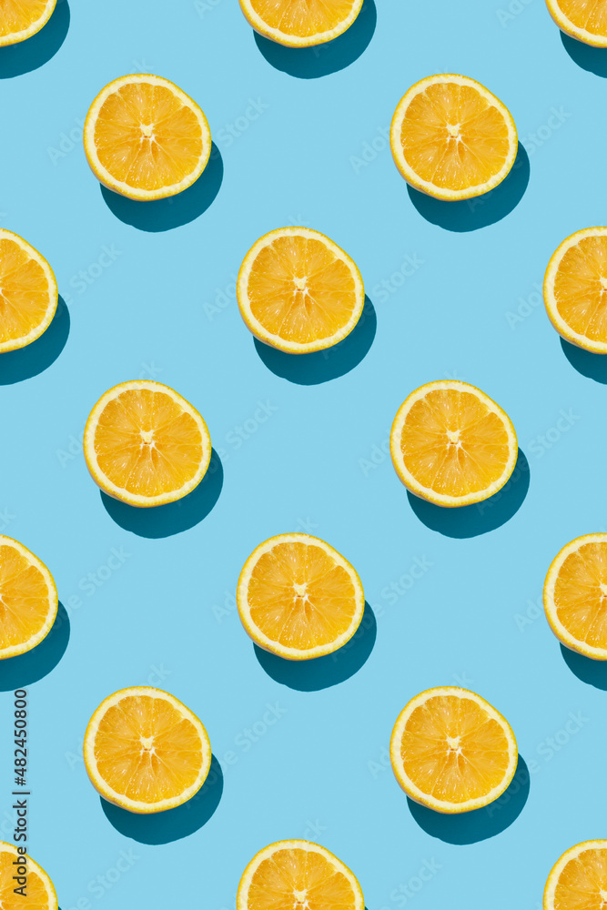 fruit pattern of fresh ripe slice oranges on blue background. top view fruit pattern of fresh ripe slice oranges on blue background. top view