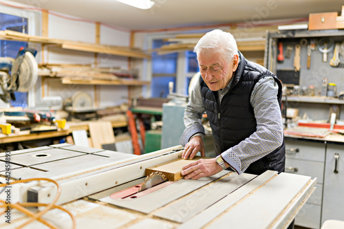 senior grandpa in the home workshop working