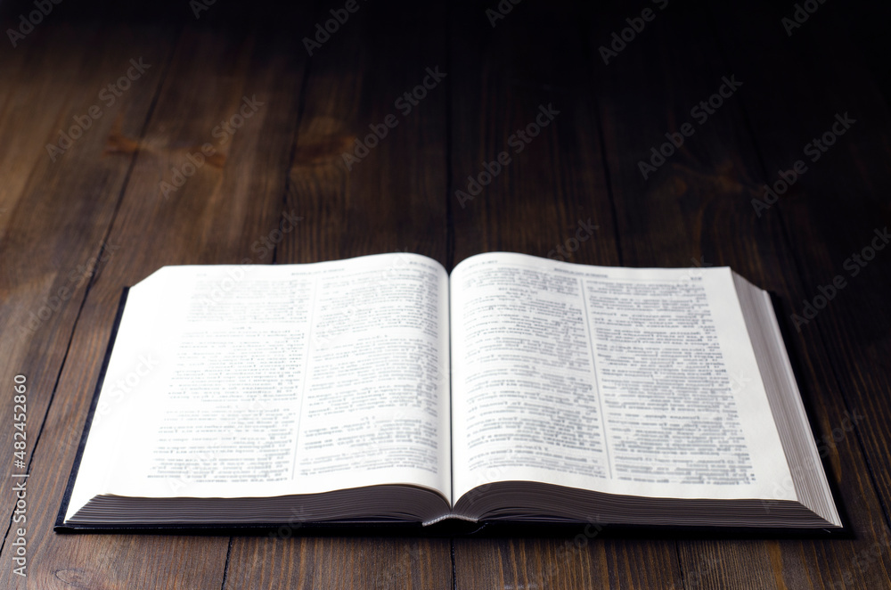 Open Bible. Open book. On a wooden background. Holy Bible. Open Bible. Open book. On a wooden background. Holy Bible.