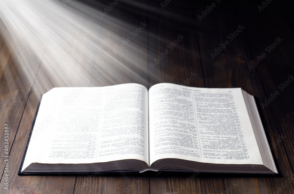 Fototapeta premium Bible. Open book. Light from a book. Old antique book. Magic, fairy tale.