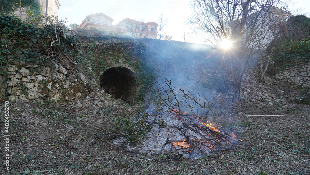 Bonfire burning wood in a fire pit during a gardening clean up session near Bar, Montenegro. Bonfire burning wood in a fire pit during a gardening clean up session near Bar, Montenegro.