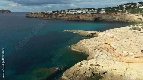 Drone flying towards Cala Codolar beach, in Sant Josep de sa Talaia, Ibiza. photo