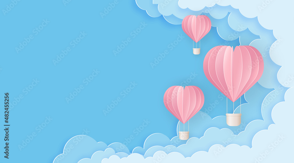 Pink balloons on the blue cloudy sky.