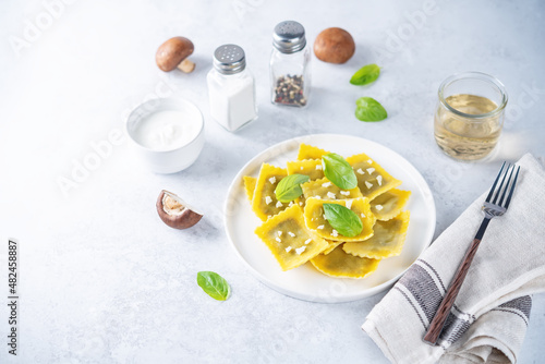 Fresh prepared Ravioli pasta with mushrooms and cheese in a plate