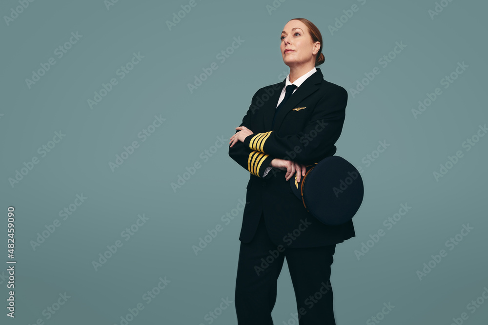 Female pilot standing in a studio Female pilot standing in a studio