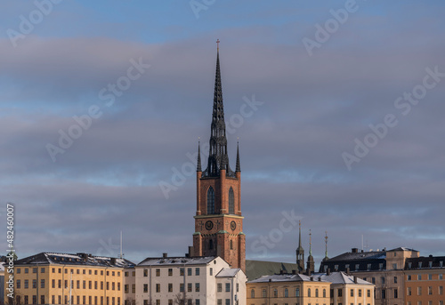 Roofs of court house and the tower of the church Riddarholmskyrkan a sunny and snowy winter day in Stockholm 
