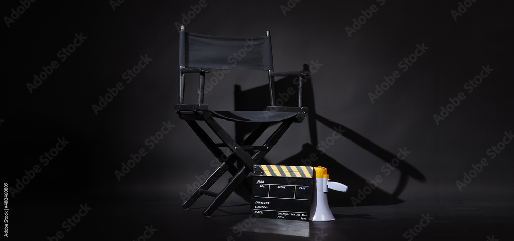 Black director chair and Clapper board or movie Clapperboard with megaphone on black background.use in video production or film cinema industry Black director chair and Clapper board or movie Clapperboard with megaphone on black background.use in video production or film cinema industry