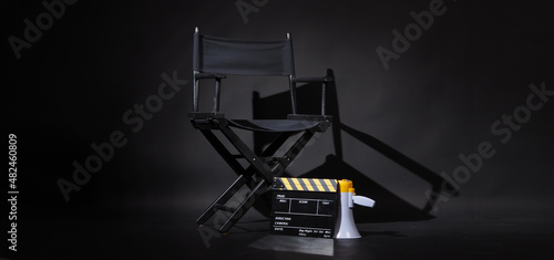 Foto Black director chair and Clapper board or movie Clapperboard with megaphone on black background