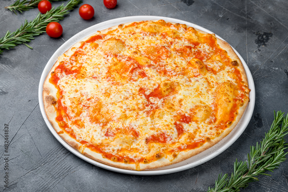 Italian pizza Margherita on plate on grey table Italian pizza Margherita on plate on grey table