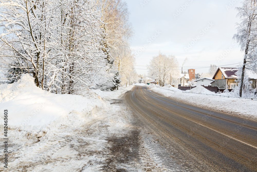 Winter Road. The road and the roadsides are covered with snow. Sunny winter day Winter Road. The road and the roadsides are covered with snow. Sunny winter day