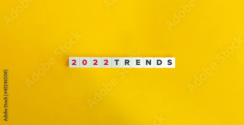 Trends for 2022 concept. Letter tiles on bright orange background. Minimal aesthetics. photo