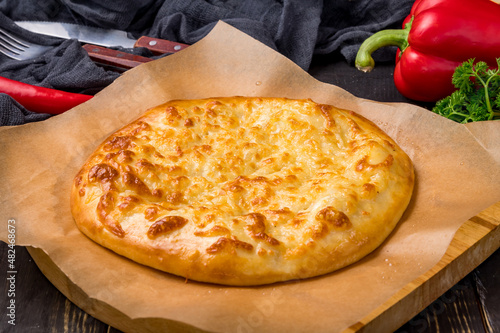 khachapuri with cheese, megrelian khachapuri, georgian cuisine on dark table photo