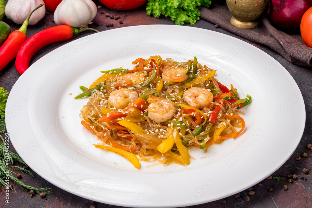 fried Rice noodles with shrimp and vegetables funchosa on dark table fried Rice noodles with shrimp and vegetables funchosa on dark table