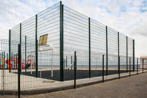 Sports ground, fenced with a high metal mesh. Without people