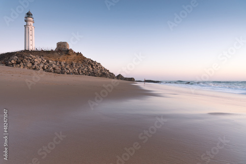 Sunset on the beach of Cape Trafalgar with the lighthouse in the background  Canos de Meca  Cadiz  Andalusia  Spain