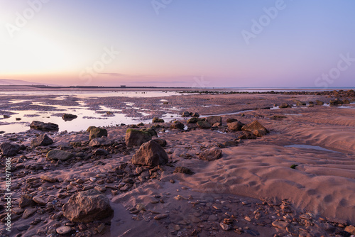 Landscape with rocks and stones on the Barbate beach next to the mouth of the Barbate river at sunrise  Cadiz  Andalusia  Spain