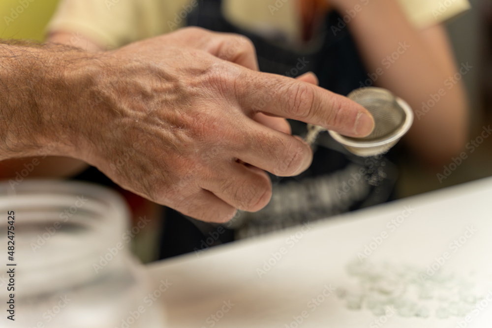 craftsman hand holding a colander