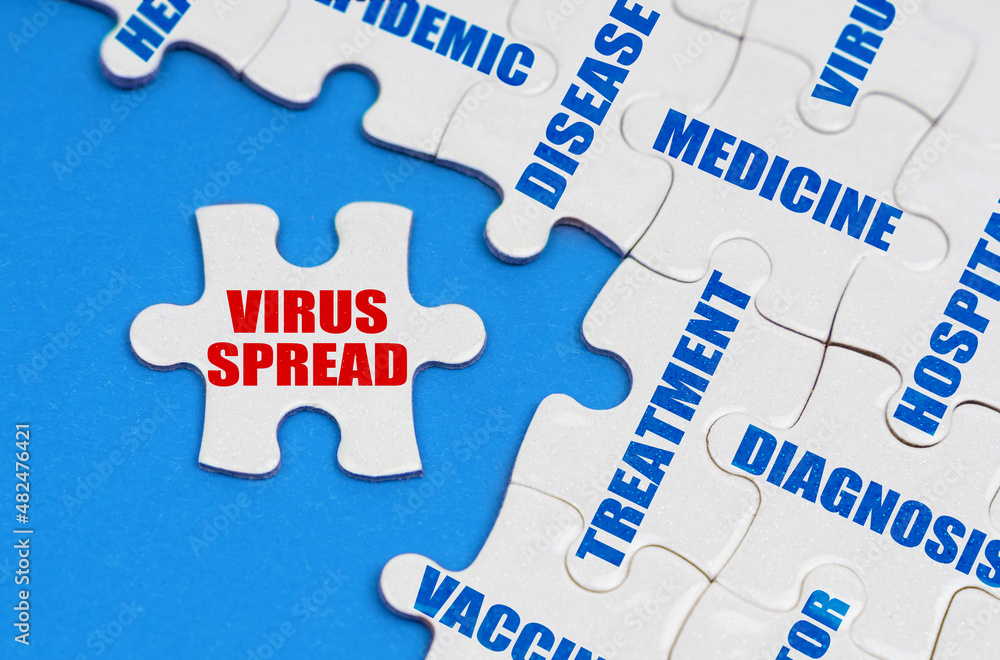 On the blue surface, puzzles with medical inscriptions, on a separate puzzle it is written - VIRUS SPREAD On the blue surface, puzzles with medical inscriptions, on a separate puzzle it is written - VIRUS SPREAD