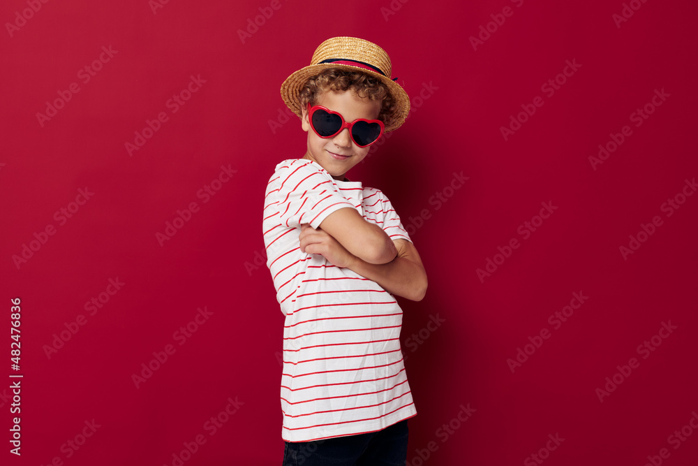 boy wearing sunglasses wearing a hat posing childish style boy wearing sunglasses wearing a hat posing childish style