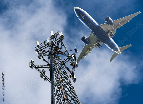 Mobile phone cell tower with 5G on the C Band frequencies with aircraft coming to land. Airlines worried about interference with plane altimeter photo