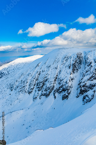 Snowy landscape of mountain trails and hills at cloudy morning