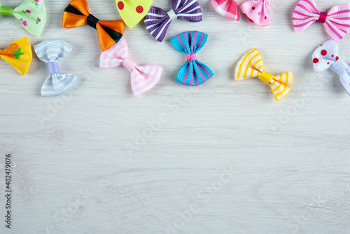 multi-colored decorative fabric bows on a wooden table top view