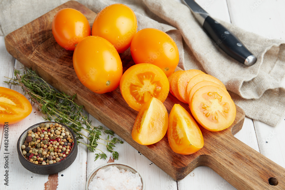 Fresh yellow tomatoes, close-up of fresh, ripe tomatoes on wooden background Fresh yellow tomatoes, close-up of fresh, ripe tomatoes on wooden background