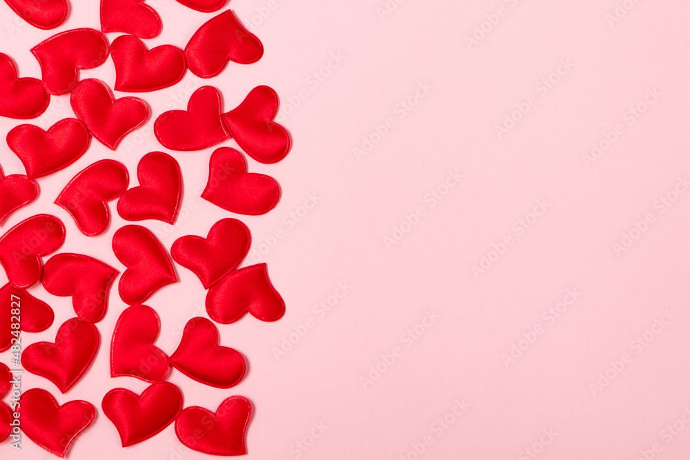 Red hearts on a pink background. Minimalistic concept for valentine's day. Place for your text.