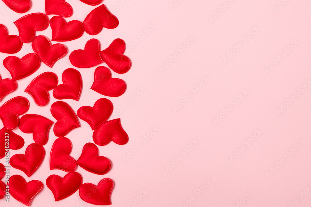 Red hearts on a pink background. Minimalistic concept for valentine's day. Place for your text. Red hearts on a pink background. Minimalistic concept for valentine's day. Place for your text.