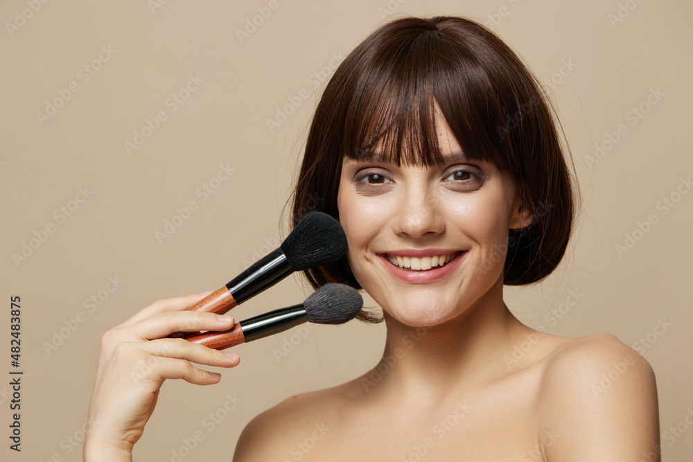 brunette makeup brushes in hand model posing cropped view brunette makeup brushes in hand model posing cropped view