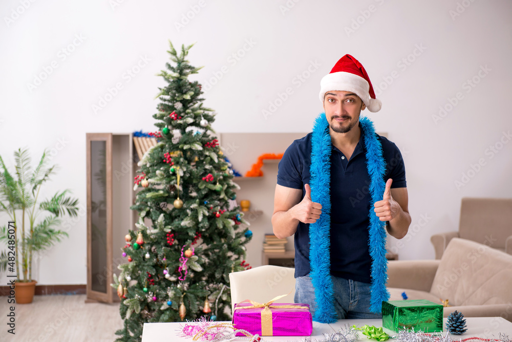 Young man celebrating Christmas at home Young man celebrating Christmas at home