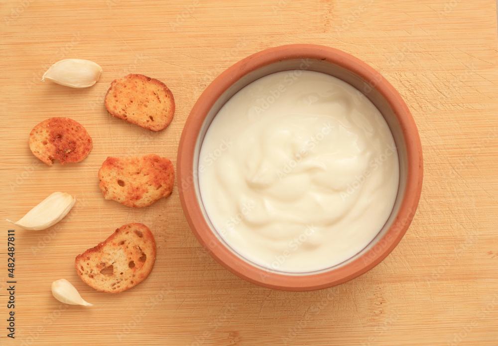 Sour cream in a wooden bowl. Farm organic product Sour cream in a wooden bowl. Farm organic product