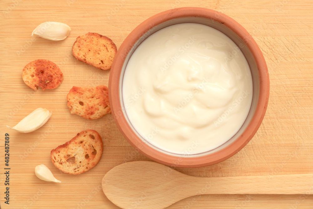 Sour cream in a wooden bowl. Farm organic product Sour cream in a wooden bowl. Farm organic product