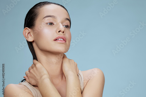 brunette touches the face skin care charm posing studio close-up Lifestyle
