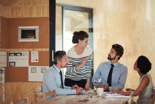 They put 'team' in teamwork. Shot of a group of colleagues working together in an office.