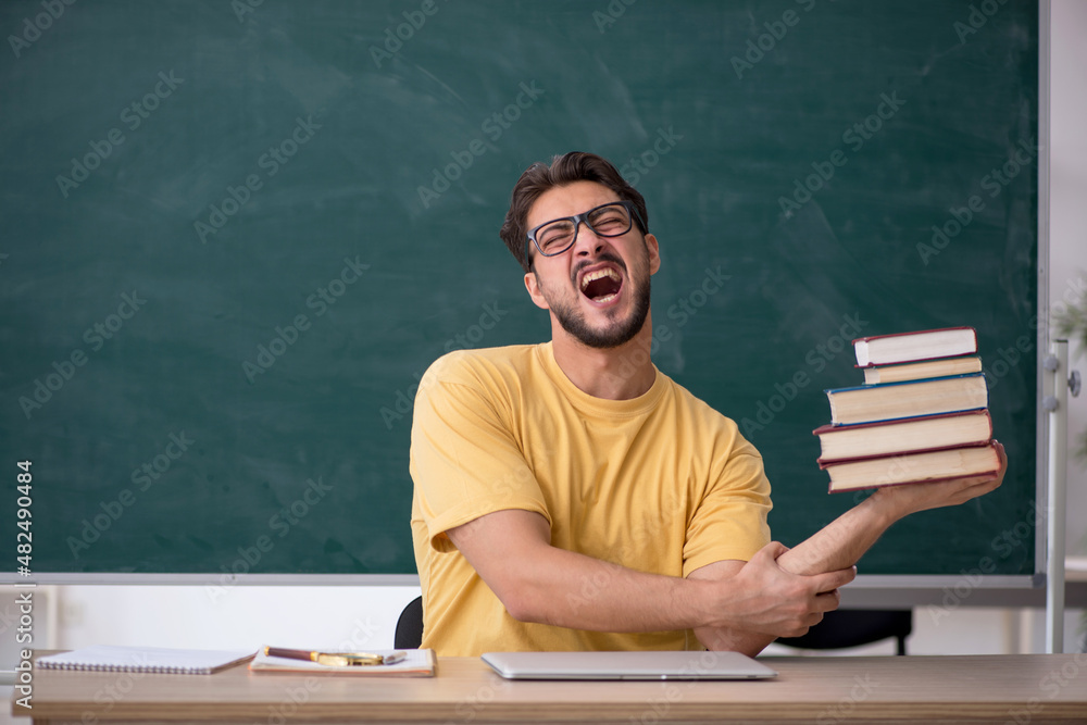 Young male student preparing for exams in the classroom Young male student preparing for exams in the classroom