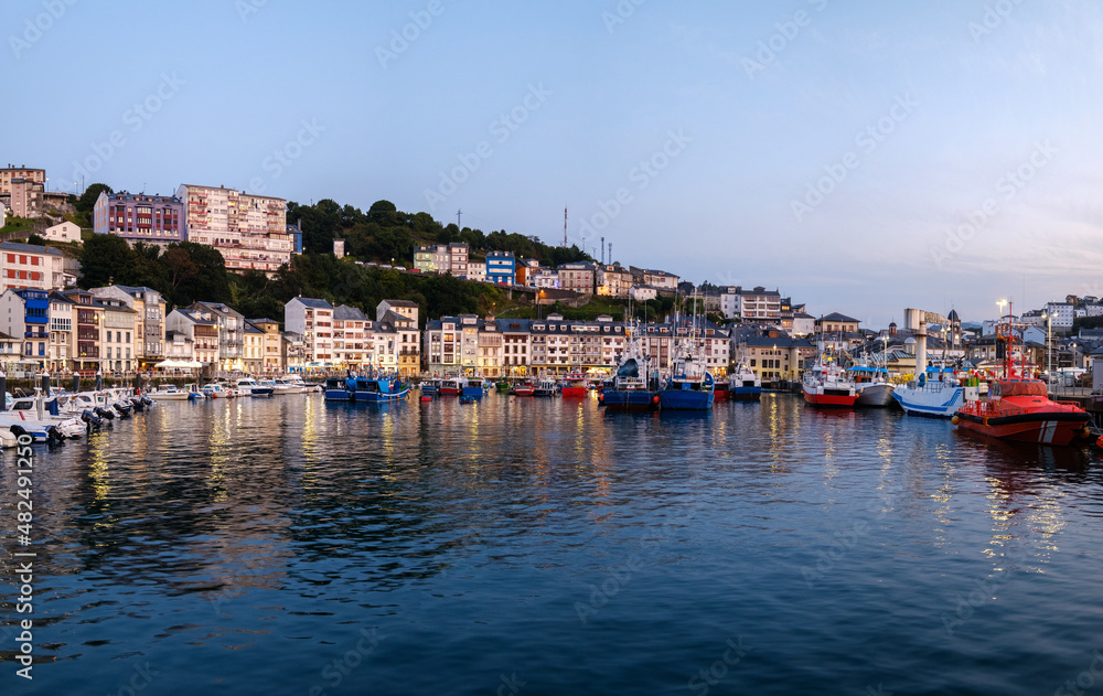Luarca, Asturias village, sunset at touristic destination Spain. Landscape with fishing and pleasure port with boats, harbor, sea and beach.