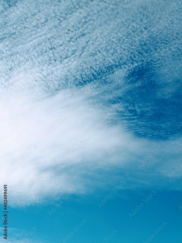 Fototapeta premium Cirrus cloud formations in the sky, vertical or portrait