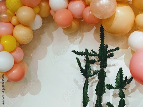 Balloon arch perched dangerously close to cactus plants - danger brewing or dangerous situation metaphor