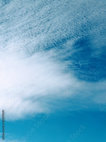 Cirrus cloud formations in the sky, vertical or portrait