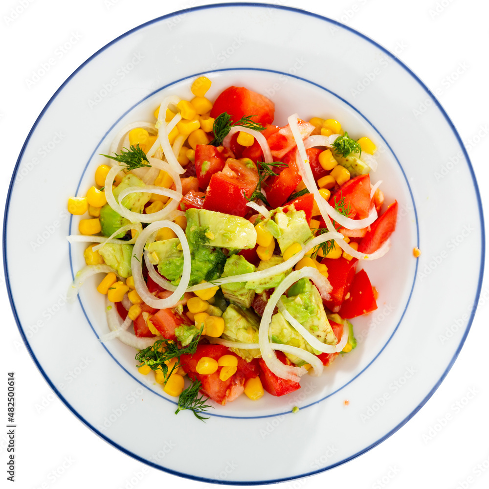 Popular all over the world appetizing vegetable salad of tomatoes, avocado, canned corn and onion, cut into rings. Isolated over white background