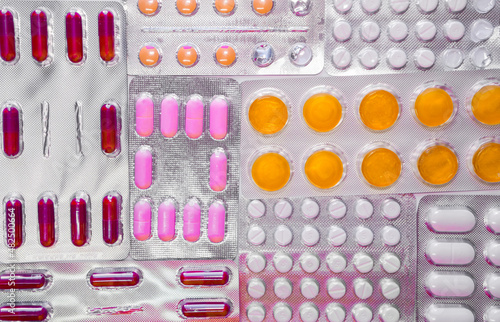 Background full of different and colorful pill blisters or medicines photo