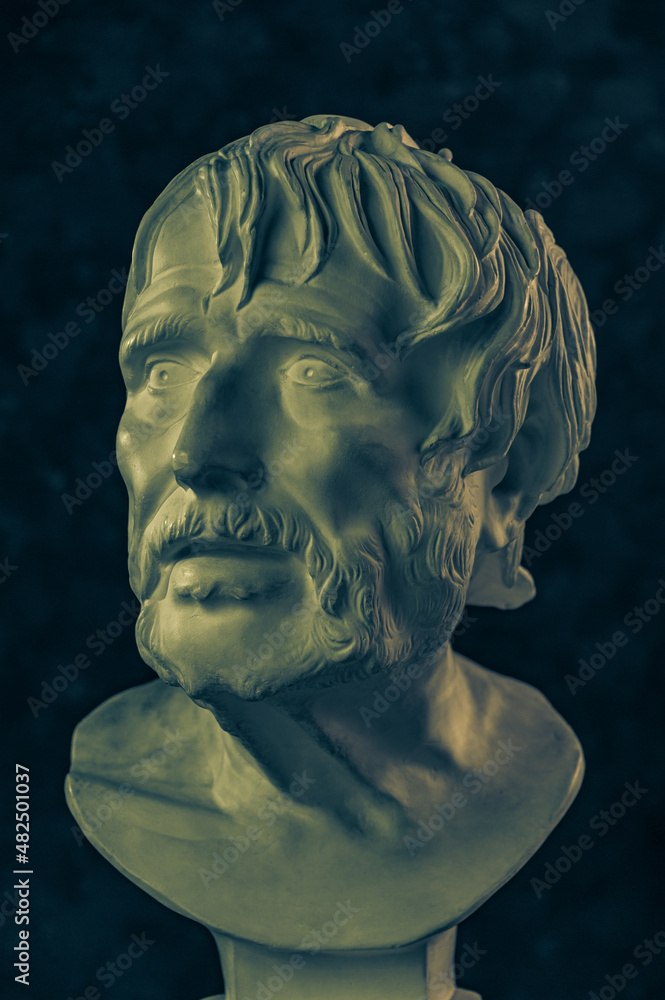 Bronze color gypsum copy of ancient statue of Lucius Seneca head for artists on a dark textured background. Seneca 4 BC-65 AD Roman stoic philosopher, statesman and tutor to the future Emperor Nero. Bronze color gypsum copy of ancient statue of Lucius Seneca head for artists on a dark textured background. Seneca 4 BC-65 AD Roman stoic philosopher, statesman and tutor to the future Emperor Nero.