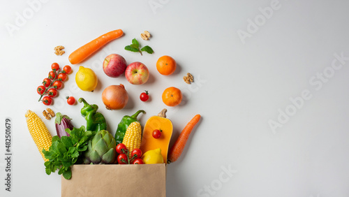 Delivery healthy food background. Healthy vegan vegetarian food in paper bag vegetables and fruits on white, copy space, banner. Shopping food supermarket and clean vegan eating concept