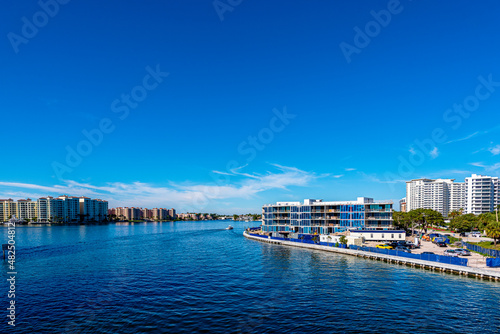 city of BOCA RATON, Florida with boat in lake. Clear blue sky with empty space 