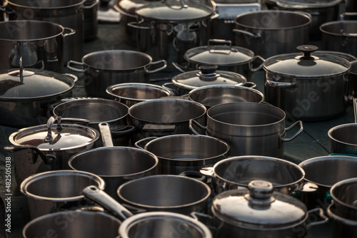 Selective blur on second hand kitchenware: metalware like pots and saucepans, pans, caldrons, in stainless steel and aluminum in the flea market of Obrenovacki Vasar. ..