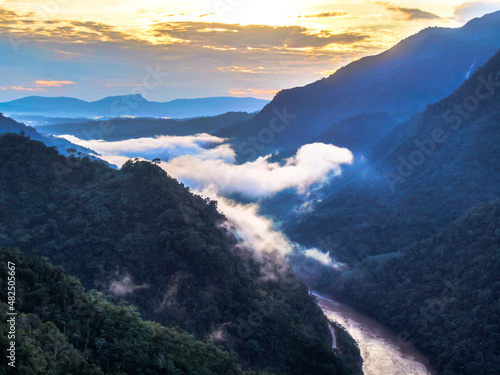 Misty rainforest with clouds over river at sunrise in Peruvian Amazon Basin/ Tarapoto photo