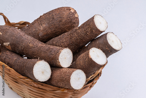 Cassava in basket on white background.